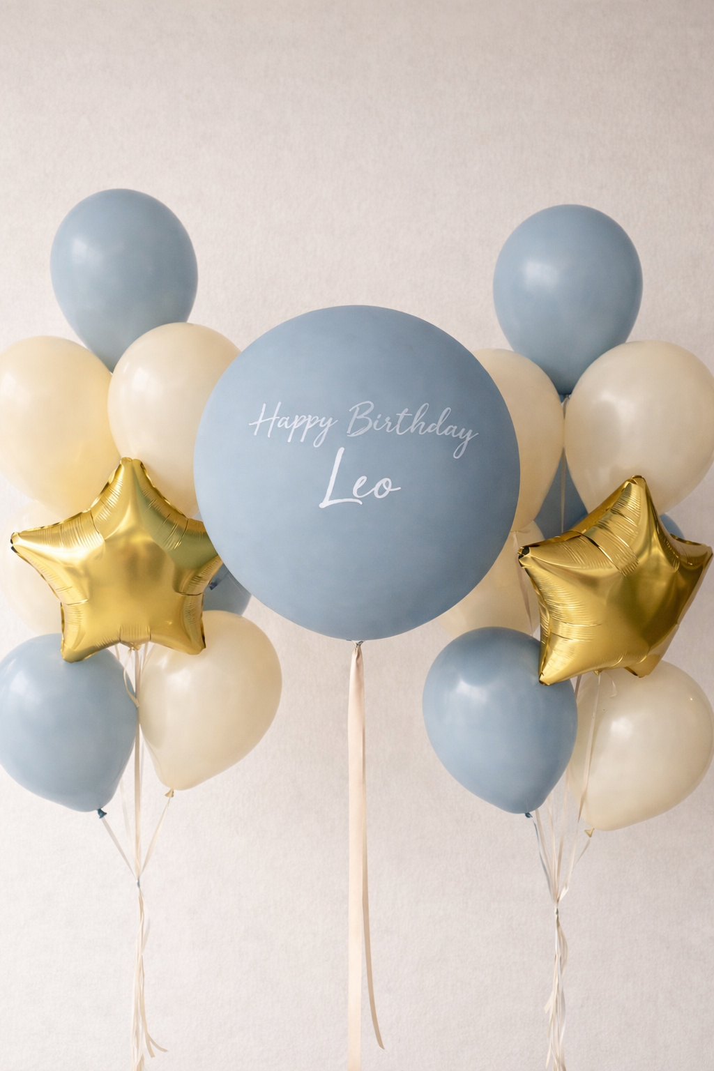 Balloon arrangement with blue, gold, and white balloons on a light background, peronalised message, helium filled, delivery.