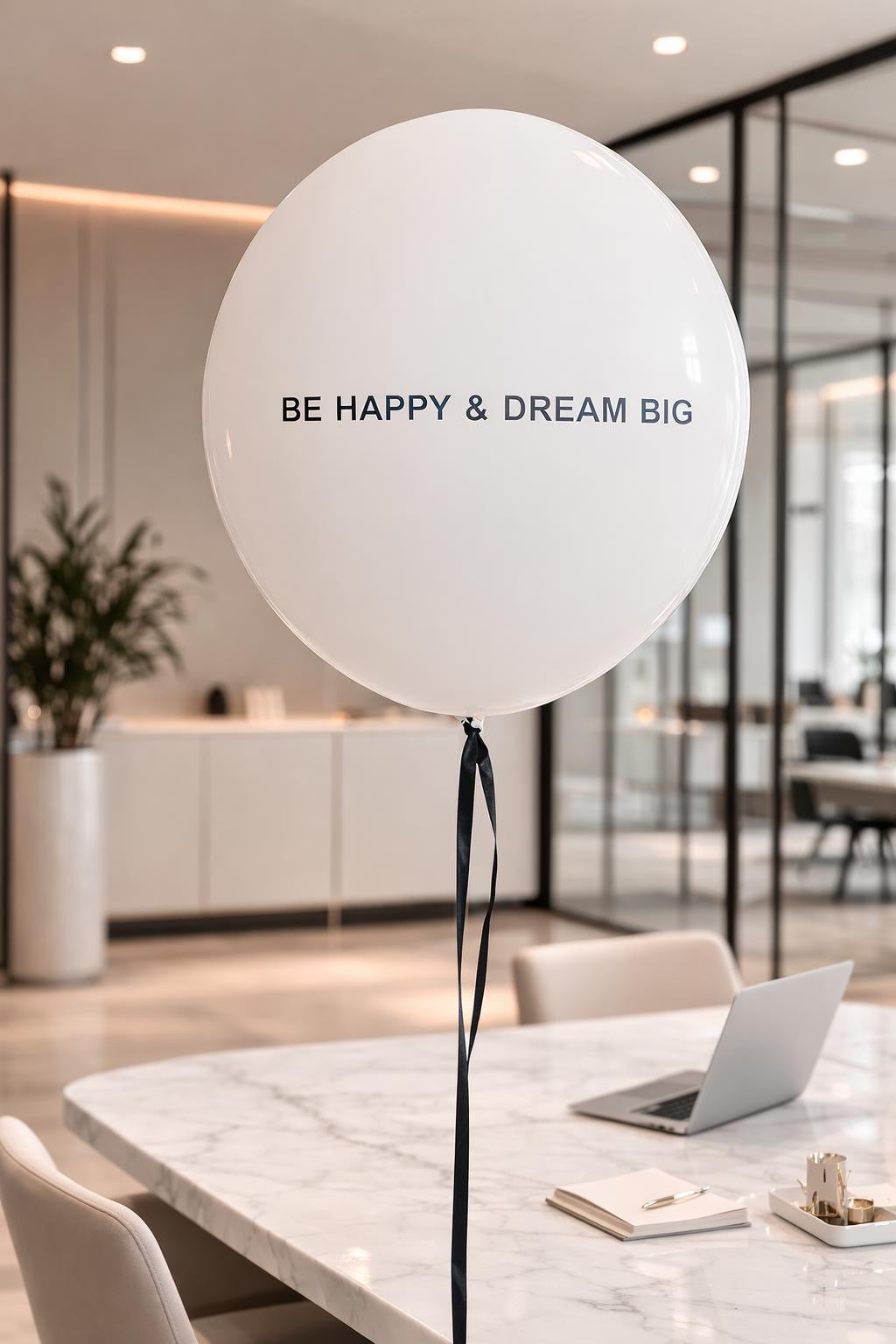 White balloon with custom writing text in a modern office setting.