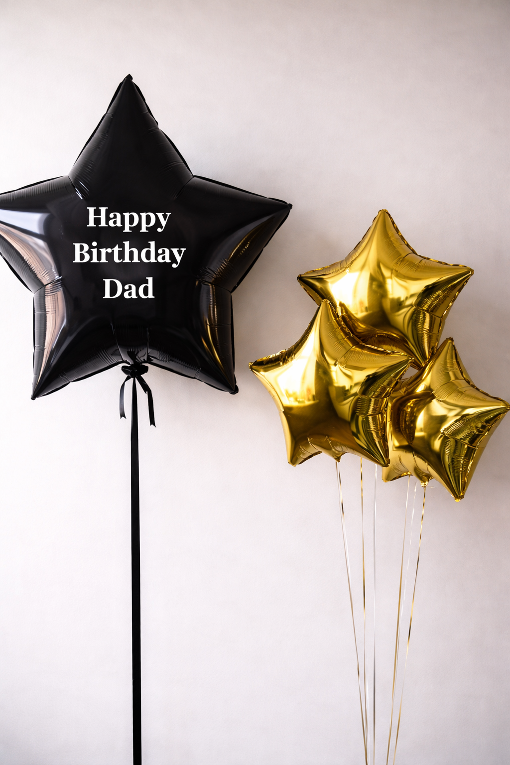 Black star-shaped jumbo balloon with 'Happy birthday' text and gold star-shaped balloons.