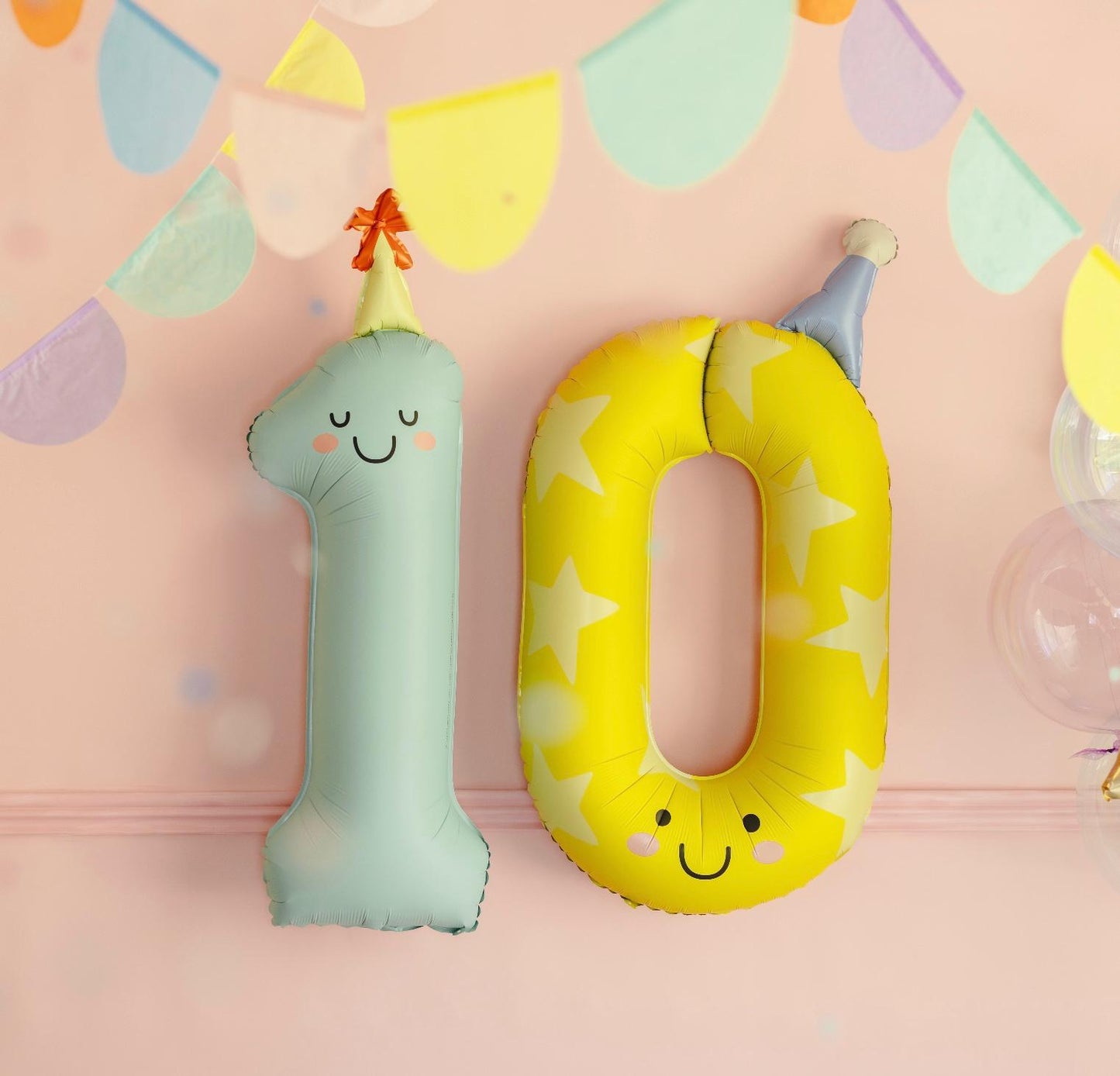 Pastel fun number 10 foil birthday balloons with party hats for a tenth birthday celebration