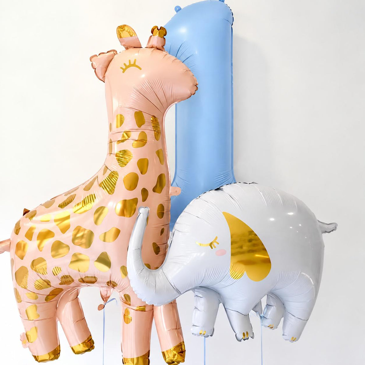 The Little Wild Edit kids birthday balloon arrangement with personalised blue number, giraffe and elephant balloons