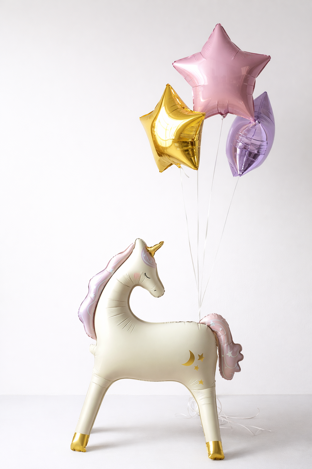 Unicorn-shaped balloon with pink, gold, and purple star balloons helium filled