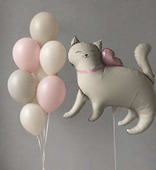 Cat-shaped foil balloon with a pink heart and blush, ivory and beige helium balloons arranged in a minimal bouquet