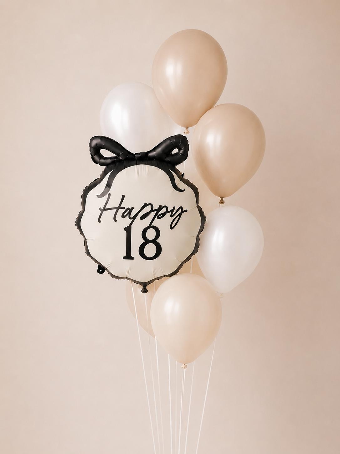 Elegant 18th birthday balloon bouquet featuring a Happy 18 bow foil balloon paired with nude, ivory and white helium balloons.