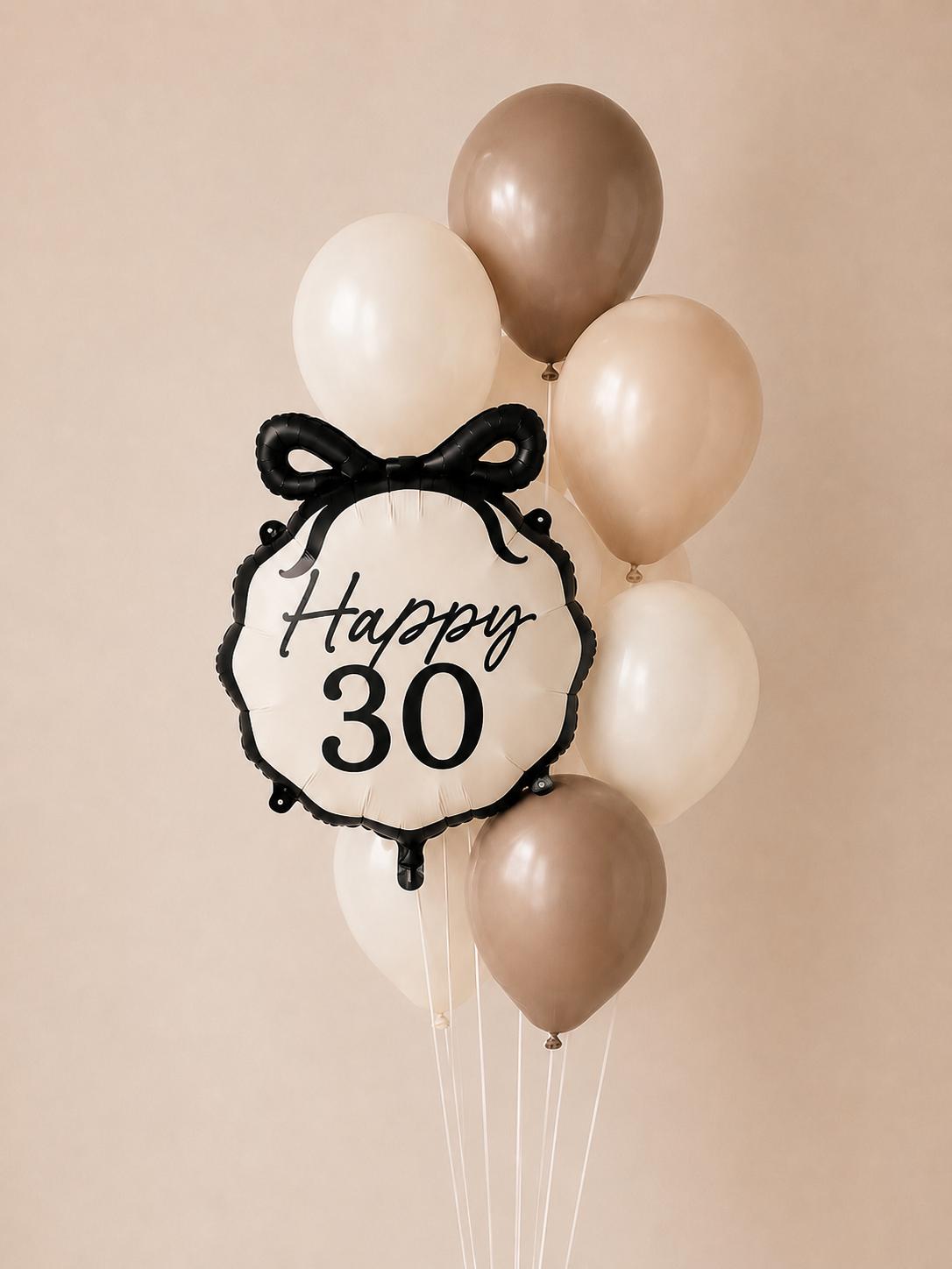 Elegant 30th birthday balloon bouquet featuring a Happy 30 bow foil balloon paired with nude, ivory and white helium balloons.