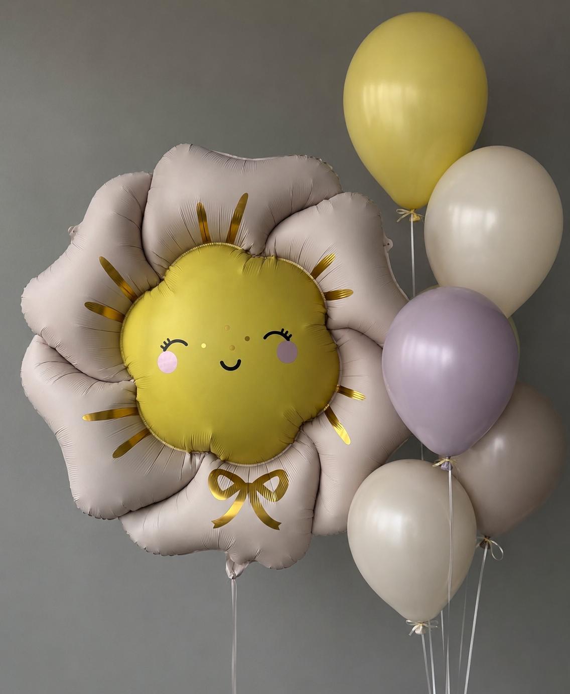 Smiling sun-shaped foil balloon paired with yellow, ivory and lavender helium balloons in a cheerful balloon bouquet arrangement.