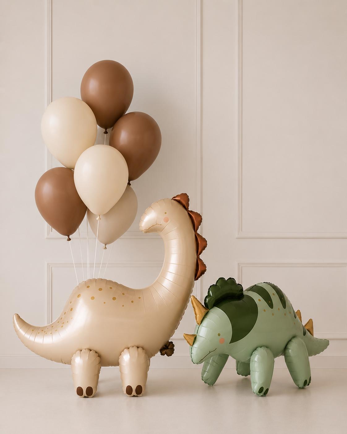 Neutral dinosaur balloon arrangement featuring a large dinosaur foil balloon paired with cocoa brown and ivory helium balloons in a minimal birthday display.
