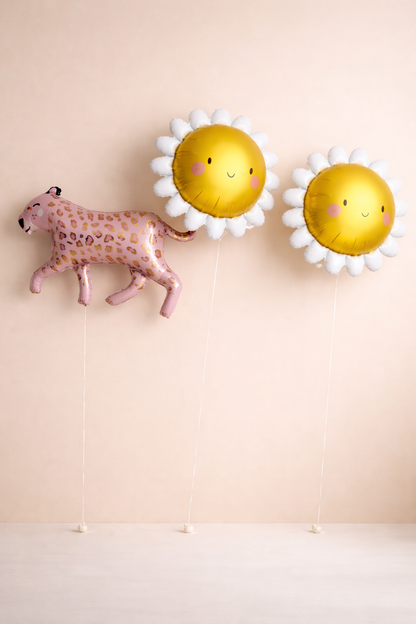 Two gold balloons shaped like sunflowers, sun with white petals and a pink leopard balloon for birthday.