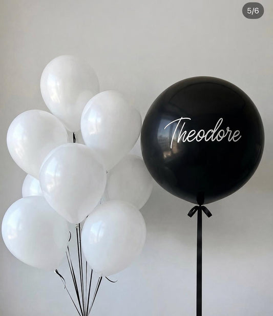 Personalised black jumbo balloon with white helium balloons and elegant black ribbon
