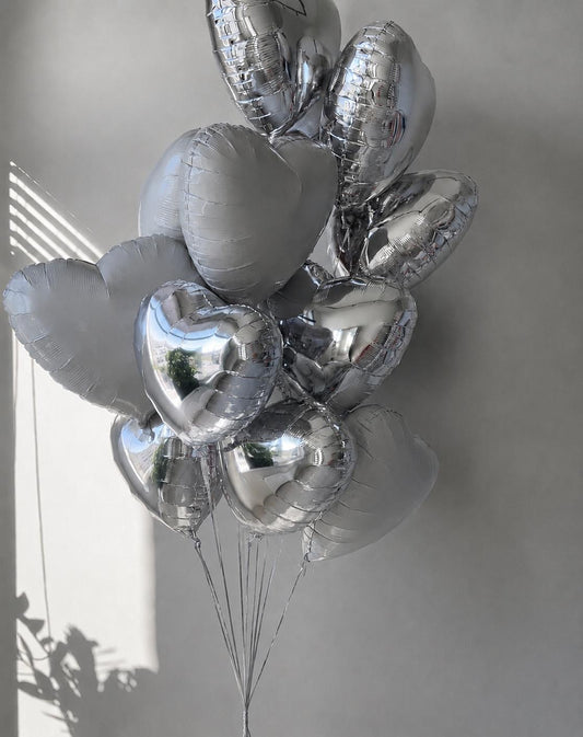 Luxury silver heart helium balloon bouquet with chrome silver and white heart balloons.