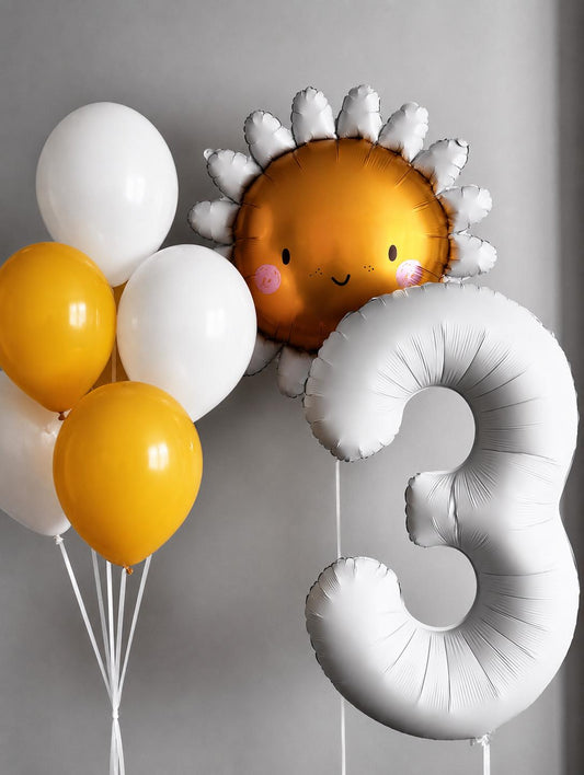 Sun-themed third birthday balloon bouquet featuring a smiling sun foil balloon, white number three balloon, and yellow and white helium-filled latex balloon