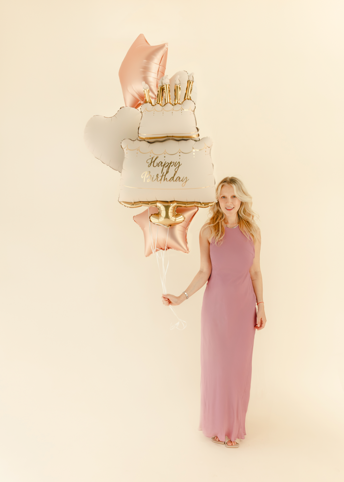 The Birthday Cake Edit helium foil balloon set with cream and gold birthday cake balloon, rose gold star balloons and ivory heart balloons.