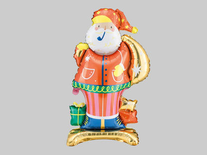 Standing Santa Claus foil balloon featuring an orange coat, white beard, star-patterned hat, metallic gold gift sack and colourful Christmas presents.