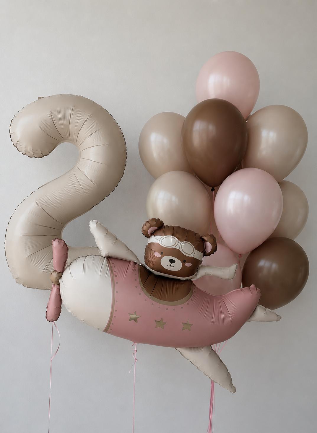 Blush aviator bear balloon with a large number 2 balloon and blush, cocoa and ivory helium balloons for a children's birthday celebration.