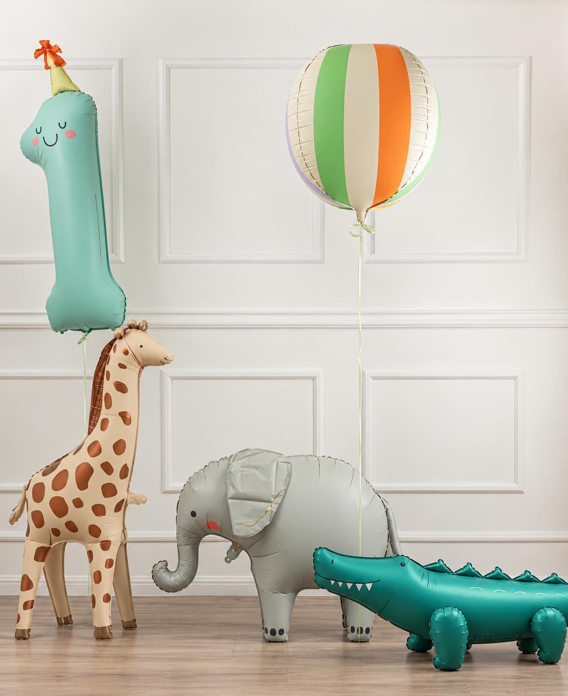 The Safari Adventure Edit kids birthday balloon arrangement featuring a giraffe, elephant, crocodile, number 1 and striped balloon.