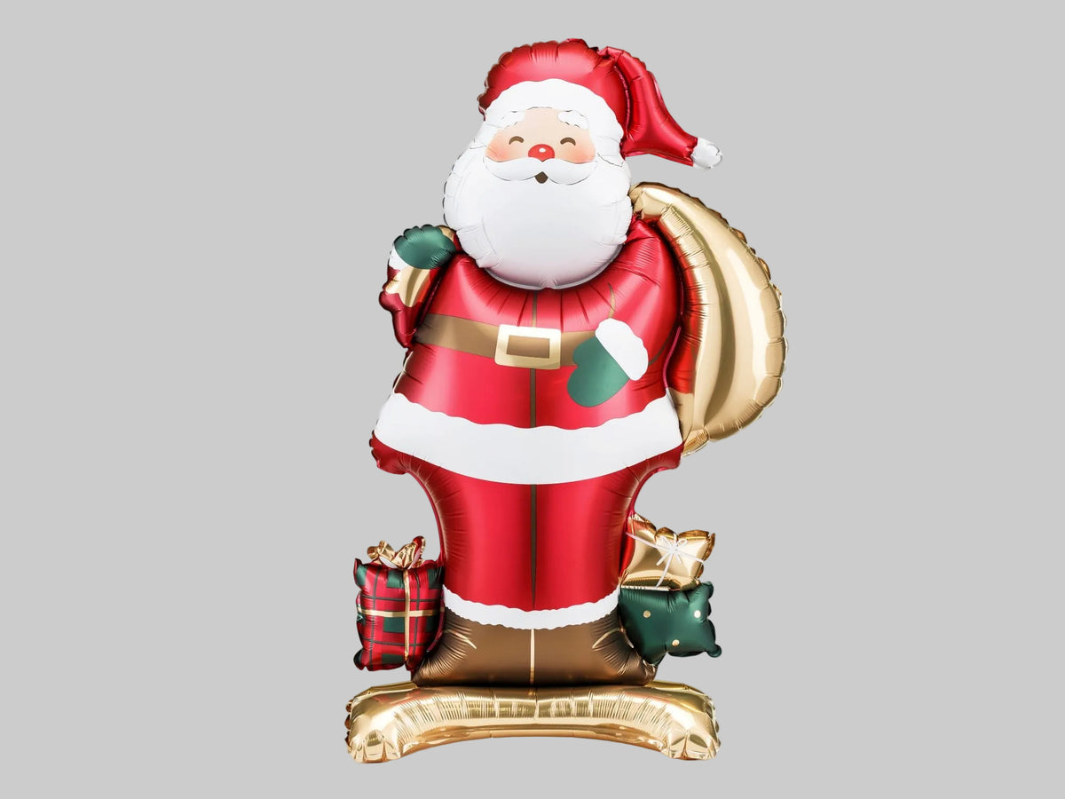 The Santa Edit standing Santa Claus foil balloon featuring a cheerful Santa in a classic red suit, carrying a metallic gold gift sack and surrounded by festive presents.