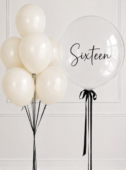 Ivory helium balloon bouquet with personalised clear bubble balloon for a sixteenth birthday.