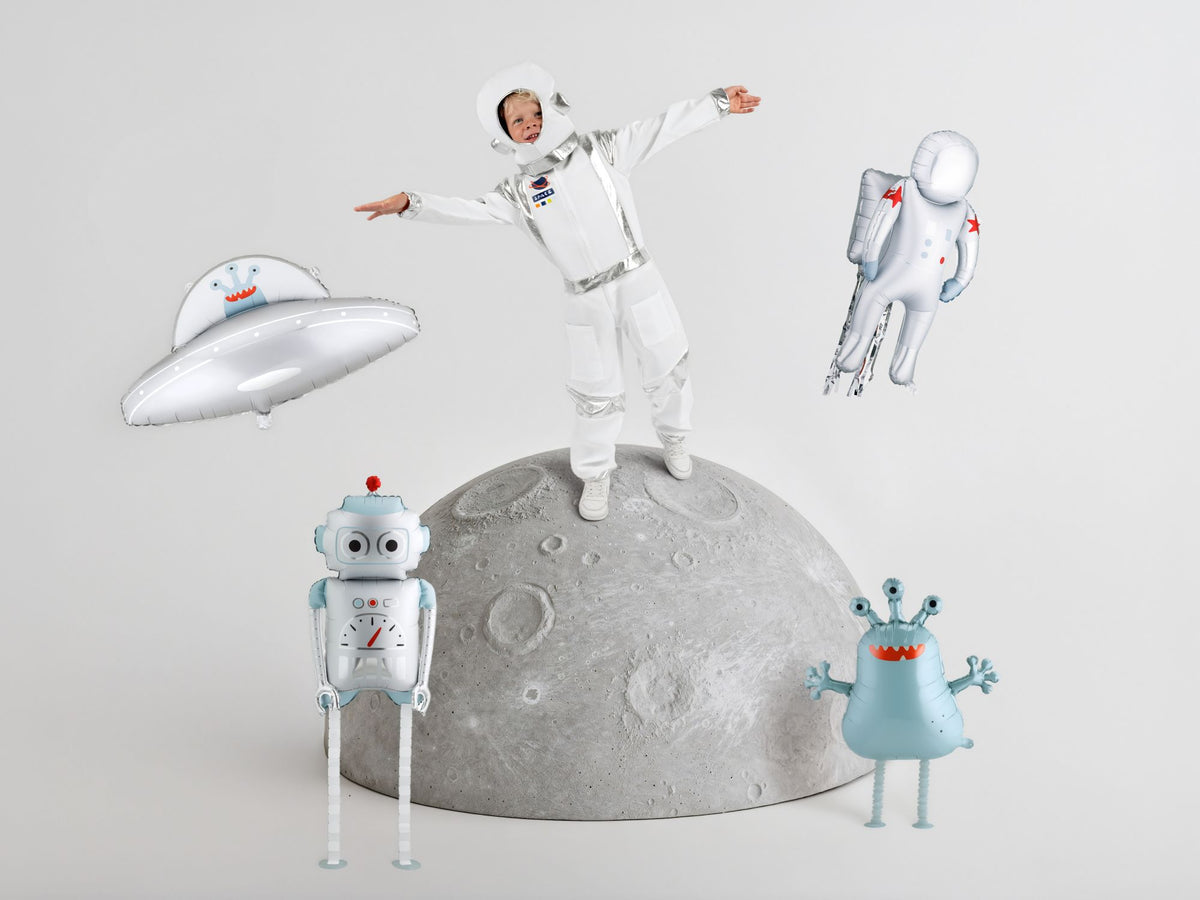 The Space Edit silver and blue robot foil balloon featuring oversized eyes, a red antenna and playful mechanical details, white and silver astronaut foil balloon featuring red star accents, blue gloves and a detailed space backpack, silver flying saucer foil balloon featuring a cute blue alien.