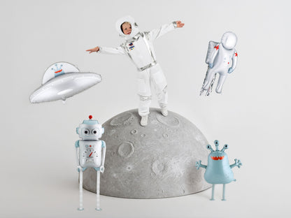 The Space Edit silver and blue robot foil balloon featuring oversized eyes, a red antenna and playful mechanical details, white and silver astronaut foil balloon featuring red star accents, blue gloves and a detailed space backpack, silver flying saucer foil balloon featuring a cute blue alien.