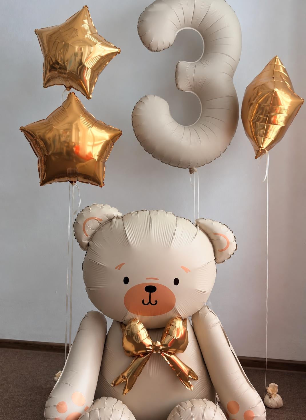 The Teddy Bear Edit birthday balloon arrangement featuring a cream teddy bear, number 3 foil balloon and metallic gold star balloons.