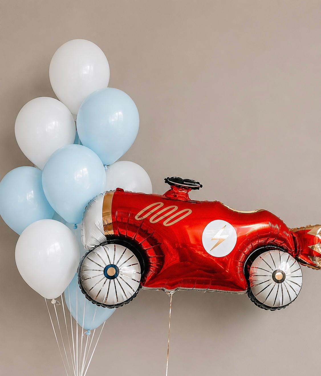 The Wheels Edit kids vehicle birthday balloon arrangement with race car and coordinating helium balloons