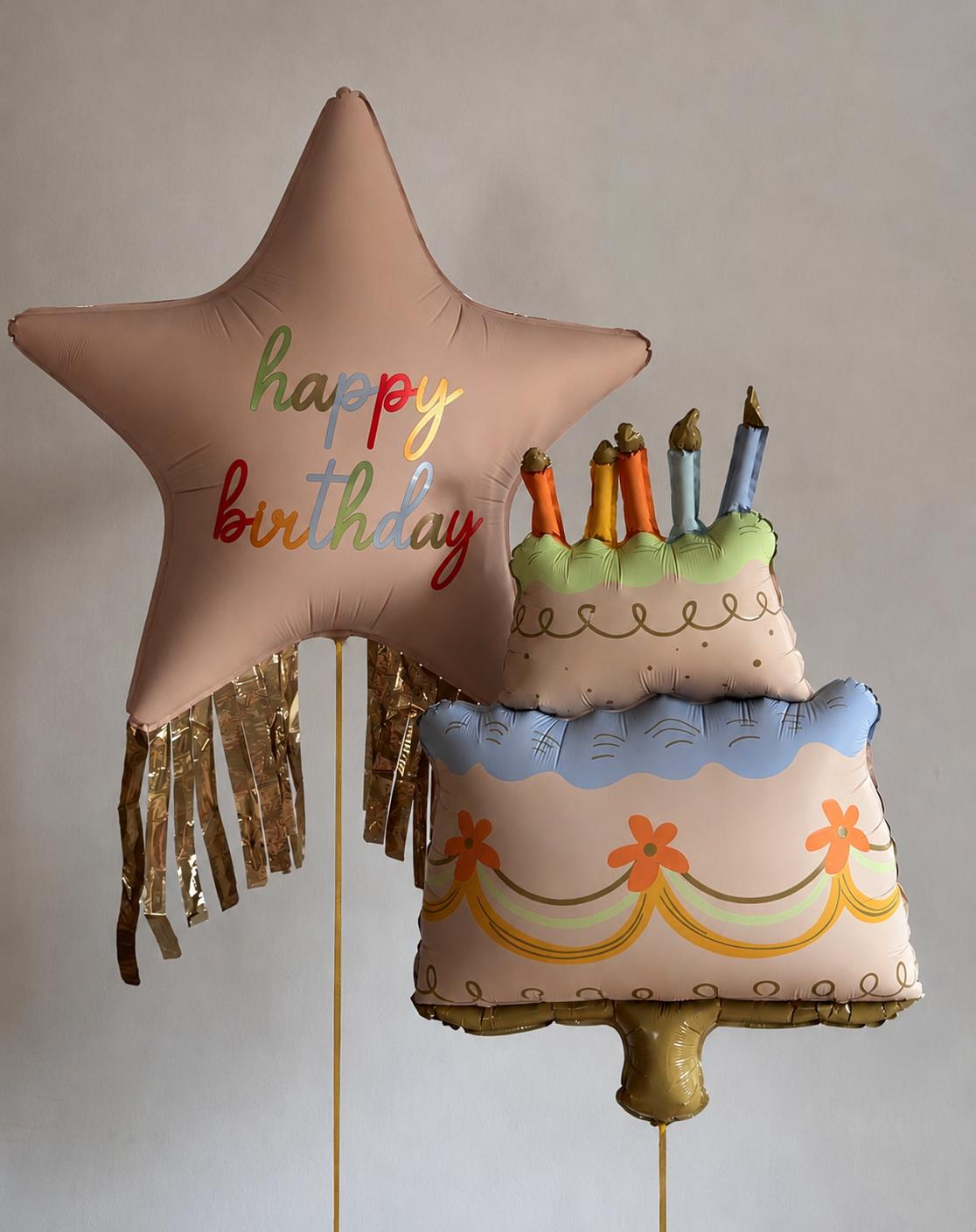 Pastel birthday star balloon paired with a birthday cake balloon and gold fringe tassels, styled for a cheerful birthday celebration.