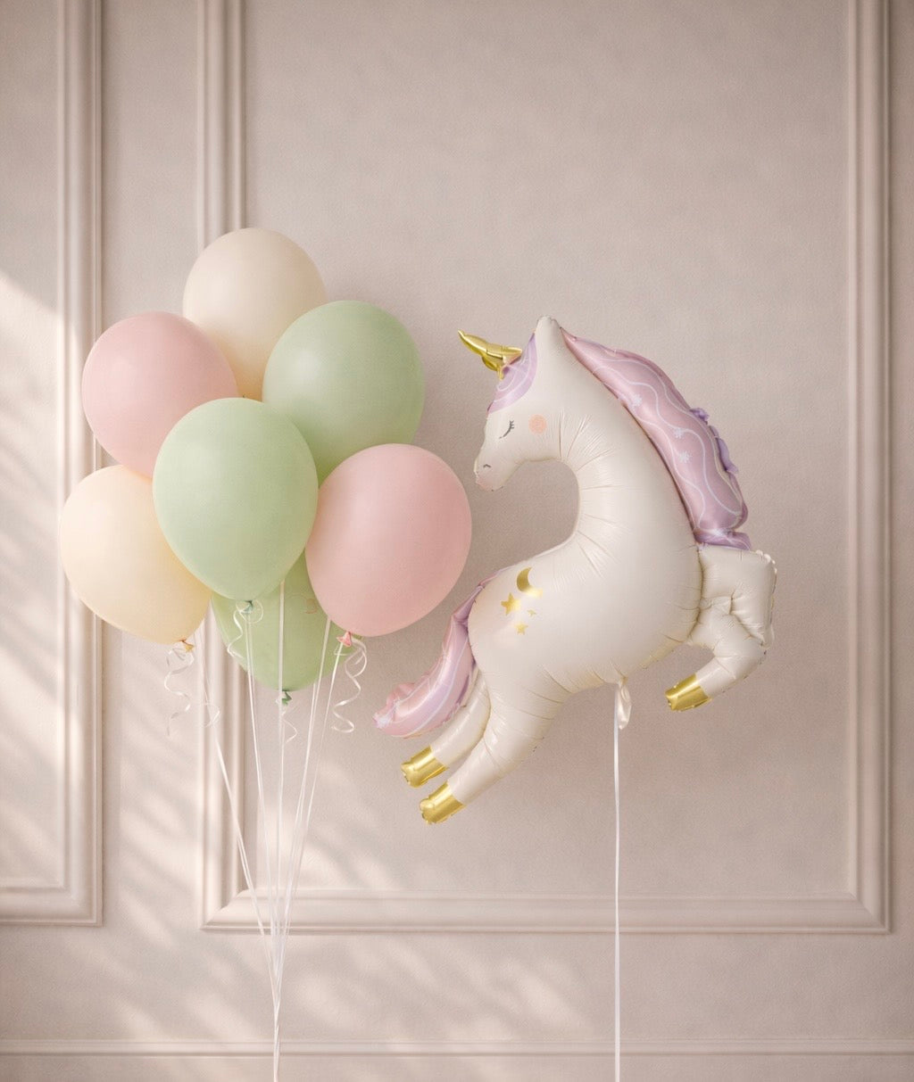 Unicorn-shaped balloon with pastel balloons for birthday